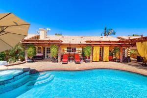 a swimming pool in front of a house at Escape To La Quinta Permit# 66714 in La Quinta