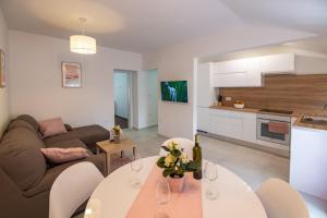 a living room with a couch and a table at Antique center Pula in Pula