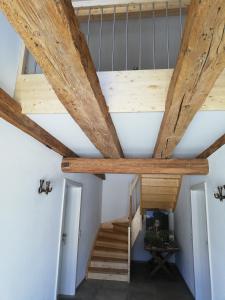 a staircase in a house with wooden ceilings at Hofgut Breitenbach in Markdorf