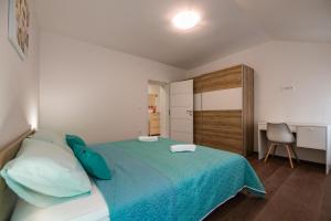 a bedroom with a bed and a chair in it at Antique center Pula in Pula