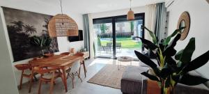 a dining room with a table and a potted plant at BOHO MARE Apartament Pobierowo in Pobierowo