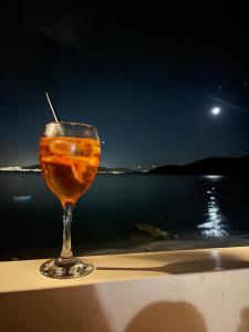 a drink sitting on a table with a view of the water at Asteria House in Animborió