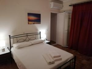 a bedroom with a bed with two towels on it at Anestis Studios in Agios Georgios
