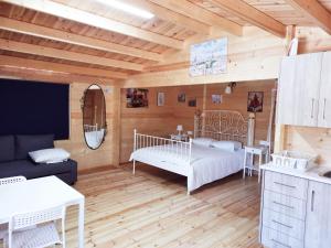 a living room with a bed and a kitchen at Cyprus Glamping Park in Ayios Theodhoros