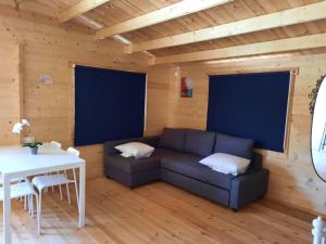 a living room with a couch and a table at Cyprus Glamping Park in Ayios Theodhoros