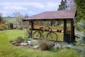 a bike parked in a gazebo in a yard at Dom Romana in Liptovský Mikuláš