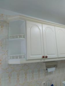 a kitchen with white cabinets in a bathroom at APARTAMENTO RAFER in Ribadeo