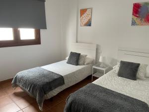 Posteľ alebo postele v izbe v ubytovaní Apartamento los Rostros