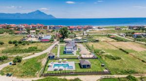 an aerial view of a house with a pool and the ocean at Katerina's Resort in Sarti