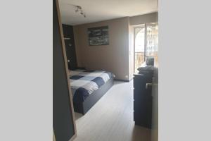 a bedroom with a bed and a window and a mirror at Villard au cœur de la vallée verte entre lac et montagne in Villard-sur-Boëge