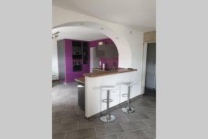 a kitchen with purple cabinets and a counter with stools at Villard au cœur de la vallée verte entre lac et montagne in Villard-sur-Boëge +27 photos