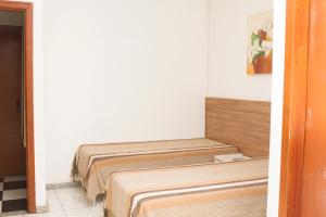 A bed or beds in a room at Pousada Lagoa