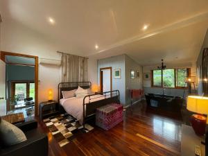 a bedroom with a bed and a living room at The Studio - Yarra Valley in Yarra Glen