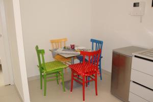 a small table with four chairs in a kitchen at B&B San Salvo in San Salvo