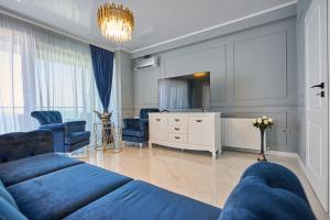 a living room with two beds and a tv at Luxury by the sea, Mamaia in Năvodari