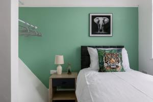 a bedroom with a bed with a tiger pillow and an elephant at Lima Apartments Ltd-4 Beds-Large property -Long Stay Deal-Business-Parking in Bournemouth