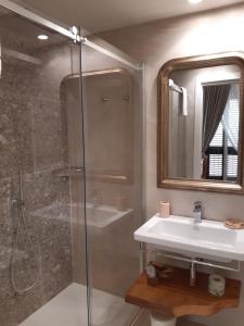 a bathroom with a shower and a sink and a mirror at Estlevante B&B in Vieste