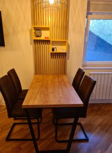 a wooden table and chairs in a room at Metropolitan in Zenica