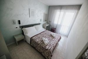 Postel nebo postele na pokoji v ubytování Hotel Gloria