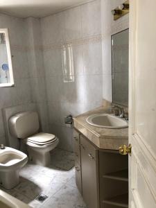 a bathroom with a toilet and a sink at B&B 518 in La Paz +8 photos