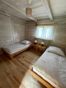 Postel nebo postele na pokoji v ubytování Domy Trapera