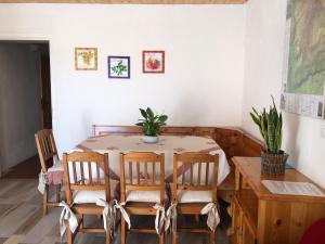 a dining room with a table and some chairs at La Libellula in Mezzaselva