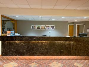 a lobby with a stone counter in a building at Motel 6-Lincoln, NE - Airport in Lincoln