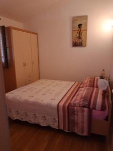 a bedroom with a bed and a painting on the wall at Apartman 2 -NENA- in Zadar