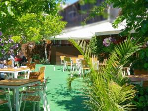 a patio with tables and chairs and plants at Casa Andreea in Braşov