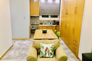 a kitchen with a table and a couch in a room at CASA VERDE di Giorgio 10 mins walk from Piraeus port in Piraeus