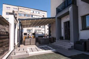 a patio of a building with awning on it at Vila Matei - Eforie Nord in Eforie Nord