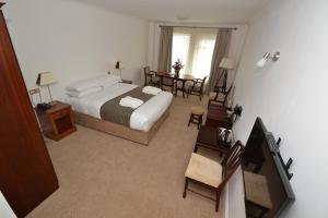 a hotel room with a bed and a table and chairs at Bay View Hotel in Killybegs