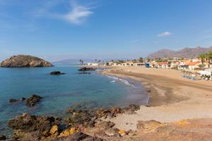 a view of a beach with people in the water at Tu Casa in Puerto de Mazarrón