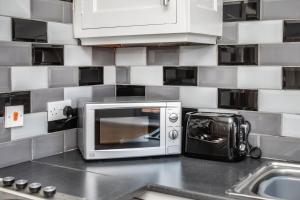 a microwave oven sitting on a counter in a kitchen at CITY CENTRE en-suite rooms in Sunderland