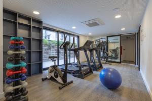 a gym with treadmills and exercise equipment in a room at Charlie Itaim Bueno Brandão in Sao Paulo