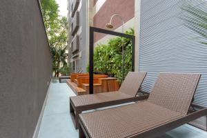 two chairs and a table on a balcony at Charlie Itaim Bueno Brandão in Sao Paulo