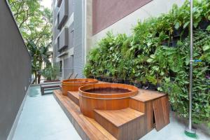 a row of wooden planters on the side of a building at Charlie Itaim Bueno Brandão in Sao Paulo