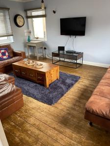 a living room with a couch and a coffee table at Seagull’s View in Lytham St Annes