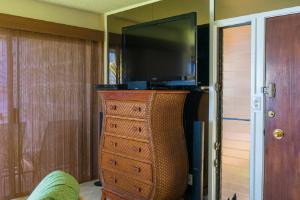 a dresser with a television on top of it at Sealodge G4 in Princeville