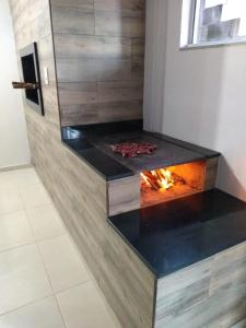 a fire pit in a bathroom with a fireplace at Hospedagem Alternativa - Ana Paula in São Joaquim