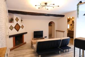 a living room with a couch and a fireplace at Rita, apartament ideal per a dos in Tremp