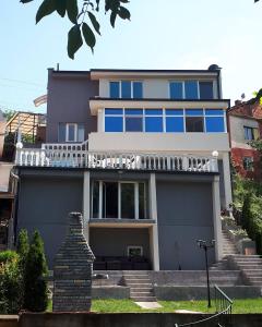 a large house with a balcony on top of it at vila Nikolaj in Niš