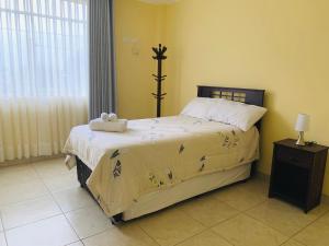 a bedroom with a bed with a stuffed animal on it at LA CASA BLANCA in Lunahuaná