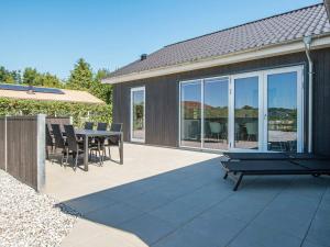 a patio with a table and chairs on it at Holiday home Juelsminde LVIII in Sønderby