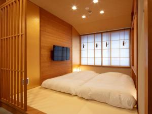 Rúm í herbergi á Tanakaya Kyoto Karasuma