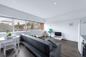 a living room with a couch and a table at homely - Watford Central Apartments (Warner Bros Studio) in Watford