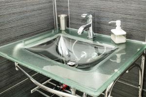a green bathroom sink with a faucet at Crescent Motel in Radium Hot Springs