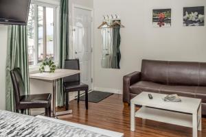 a living room with a bed and a couch and a table at Crescent Motel in Radium Hot Springs