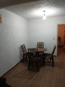 a dining room with a table and two chairs at Casa con alberca Ixtapa Zihuatanejo in Ixtapa