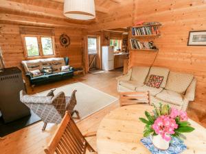 a living room with a table and chairs in a cabin at The Beach Shack in Carmarthen